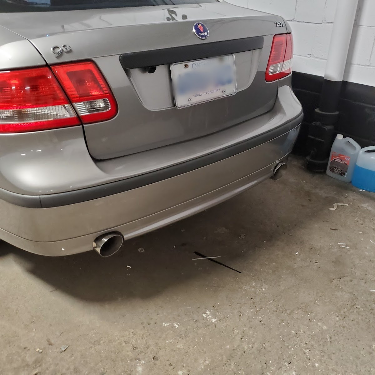 Saab on the bay at Markham Muffler — fresh exhaust tip, clean weld